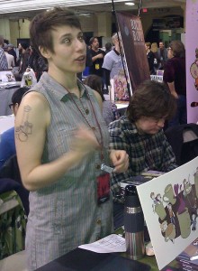 Meredith Gran pictured at the recent MoCCA Festival; at press time, it was not confirmed if the evil eyes were an artifact of flash photography, or the burning glow of comics ideas trying to directly inscribe themselves onto pages without waiting to be drawn.